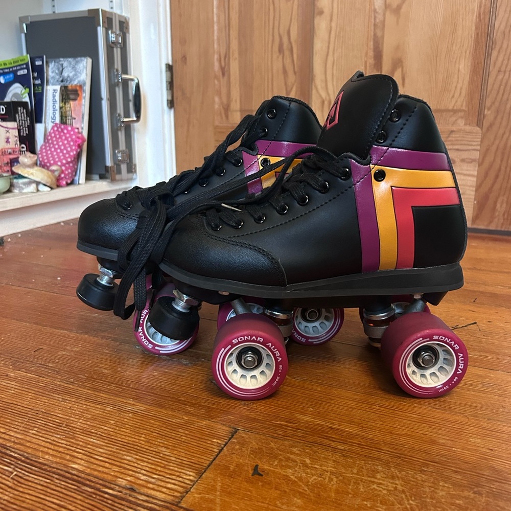 Black Roller Skates with Pink and Gold Accents